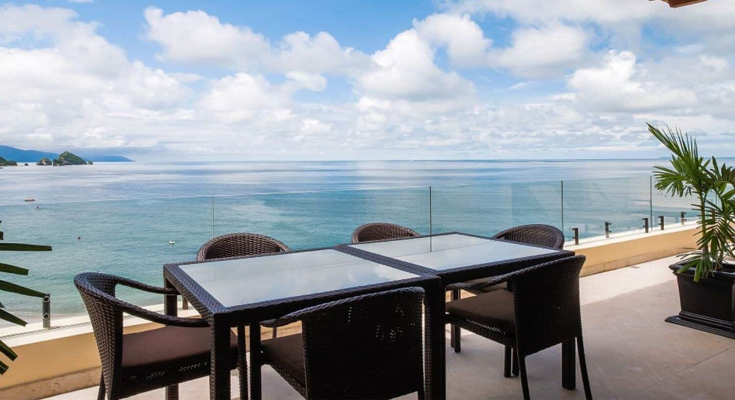 A private outdoor patio with table and chairs and views of Banderas Bay