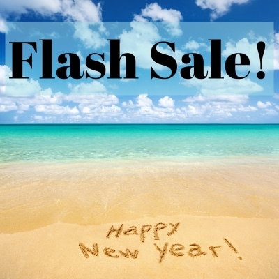 A turquoise ocean with gently waves onto a sandy beach wit Happy New Year written in the sand, and some text above in the clouds that says Flash Sale!