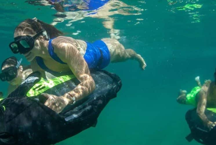 a group of people on underwater motorized power snorkels