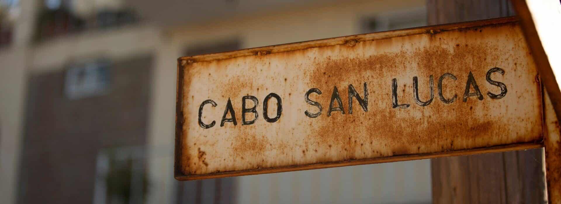 A rusty metal sign that says CABO SAN LUCAS