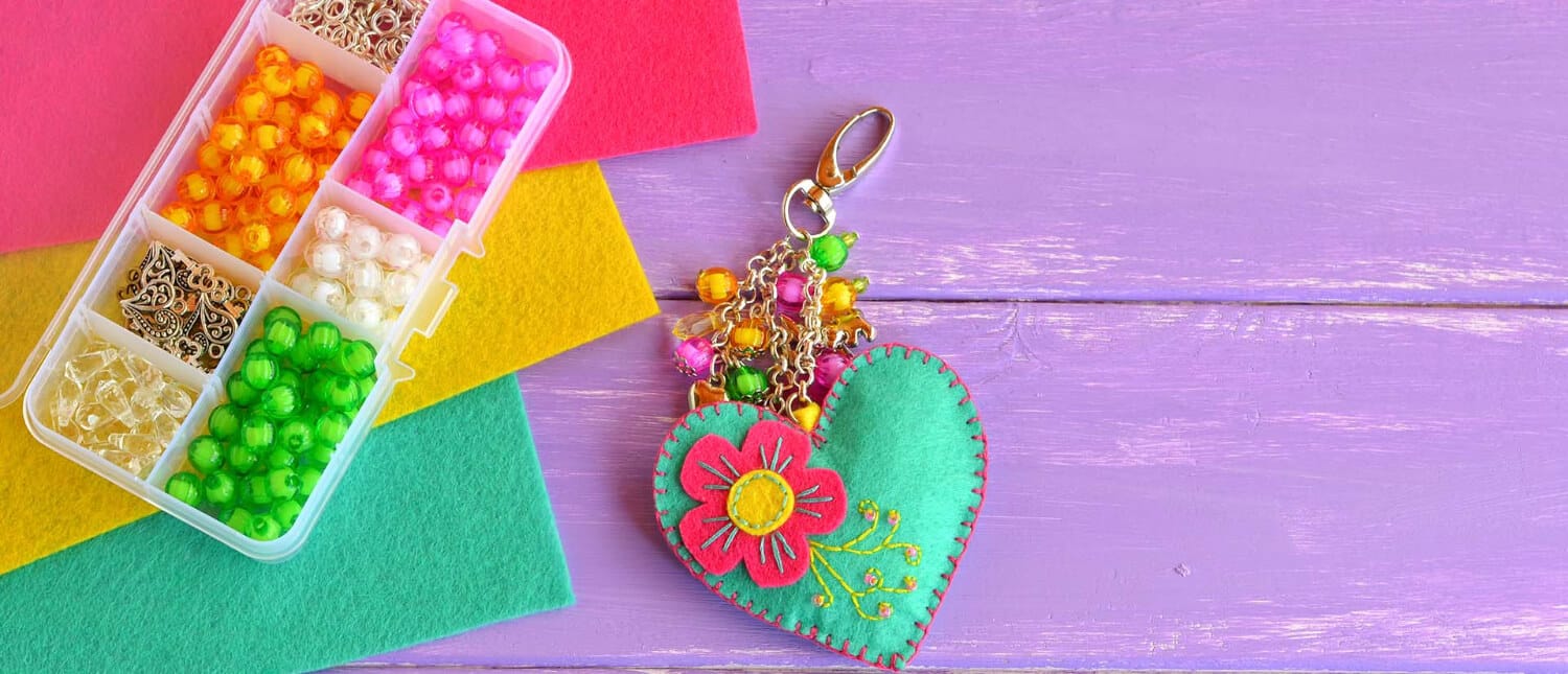 pieces of colorful felt made into a keyring with a felt flower