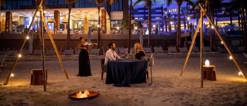 a couple having a romantic private dinner on the beach