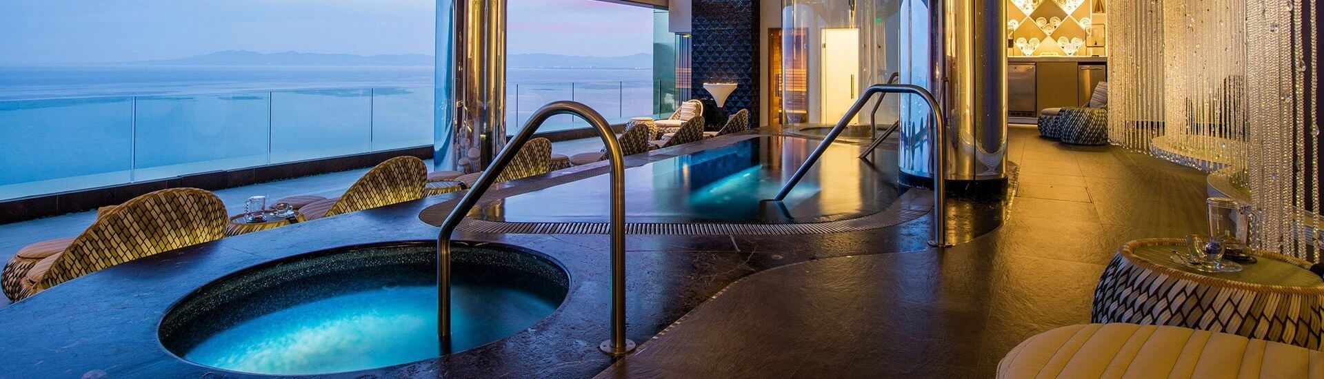 A spa with several pools, oversized chairs to sit and look out over the expansive ocean views.